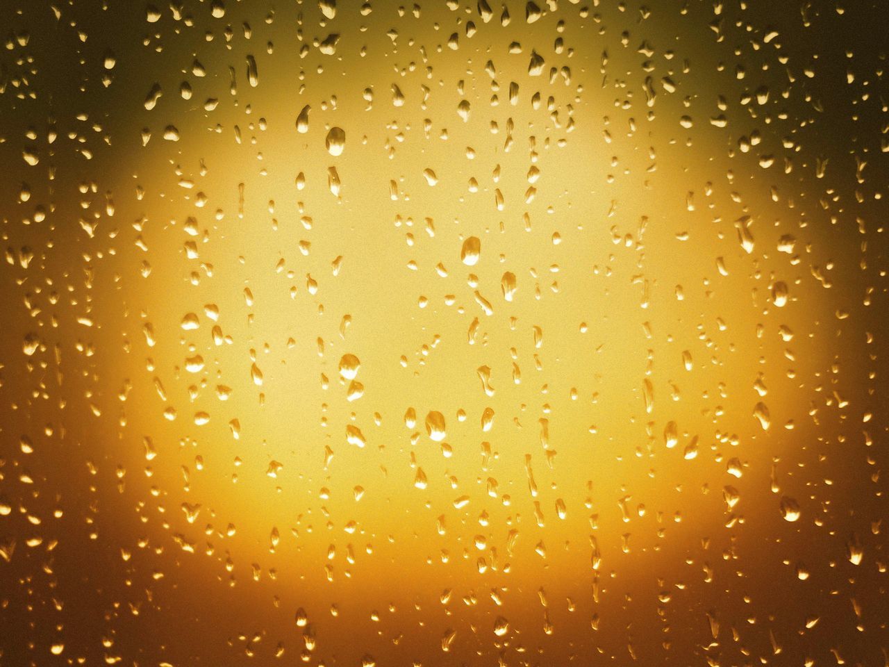 CLOSE-UP OF RAINDROPS ON GLASS WINDOW