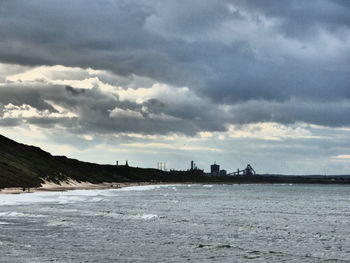 Scenic view of sea against cloudy sky