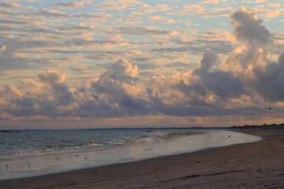 Scenic view of beach against sky during sunset