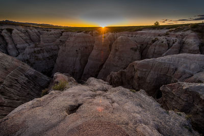 Rock formations against sky during sunset