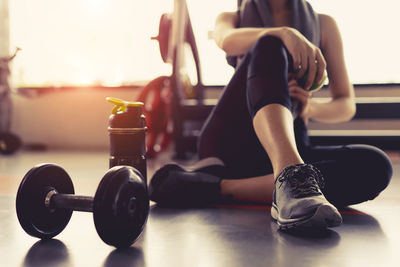 Young woman sitting in gym