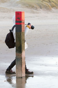 People on wooden post at beach