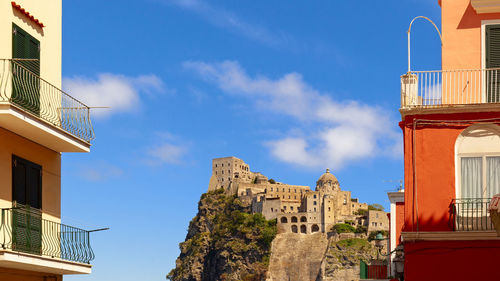 Low angle view of buildings against blue sky