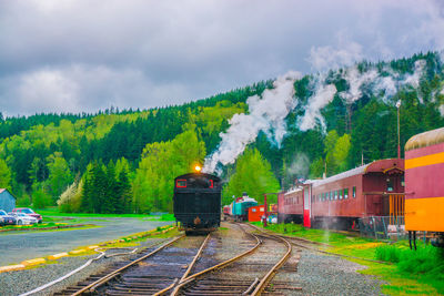 Train on railroad track against sky