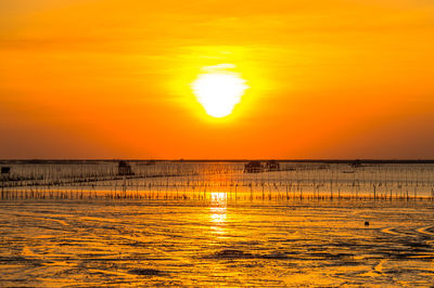 Scenic view of sea against romantic sky at sunset