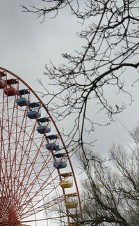 Low angle view of ferris wheel against sky