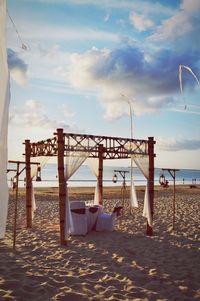 Lifeguard hut on beach against sky