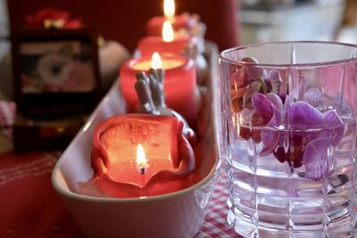 Close-up of lit tea light candles on table