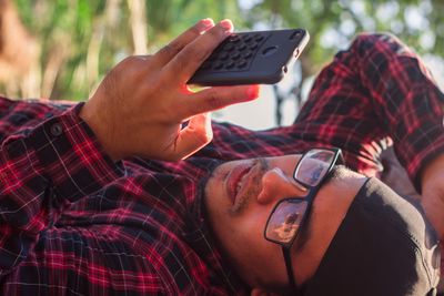 Midsection of man using mobile phone
