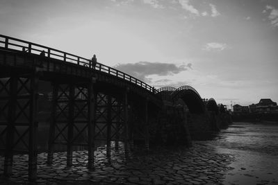 Low angle view of bridge over city against sky