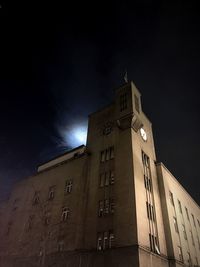 Low angle view of illuminated building against sky at night