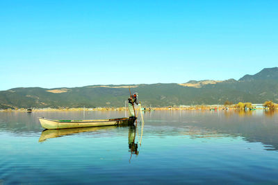 Calm lake with mountains in background