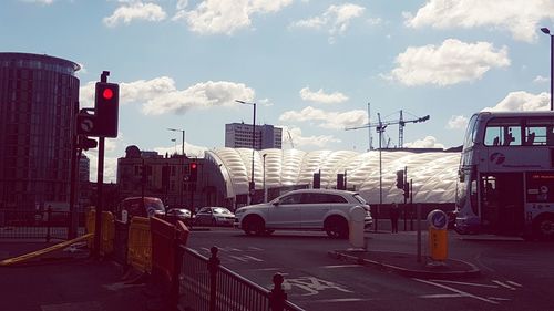 Traffic on road against buildings in city