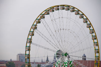 Low angle view of ferris wheel against clear sky