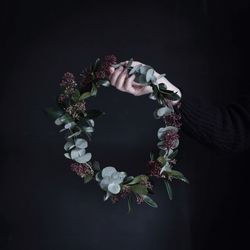 Woman holding flowers against black background