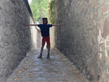 Rear view of woman walking on footpath