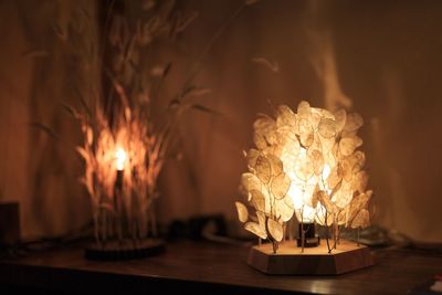 Close-up of burning candle on table