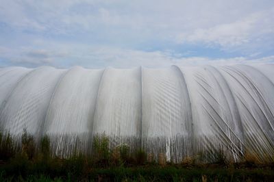 Scenic view of greenhouse against sky