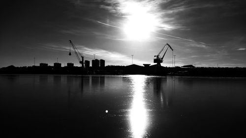Silhouette of city at riverbank