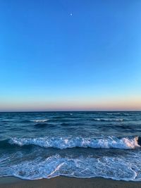 Scenic view of sea against clear blue sky