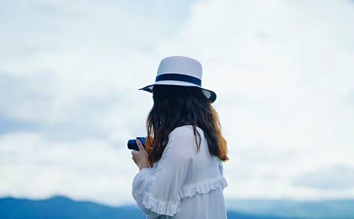Rear view of woman photographing