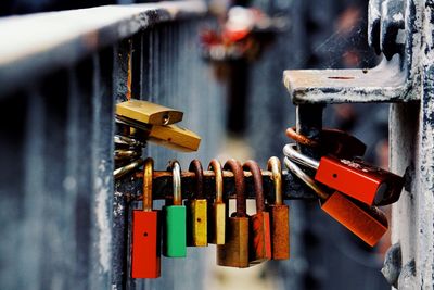 Close-up of padlocks hanging on railing