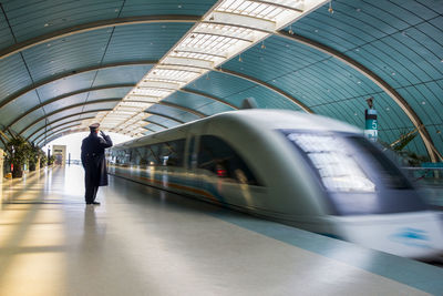 Blurred motion of train at railroad station