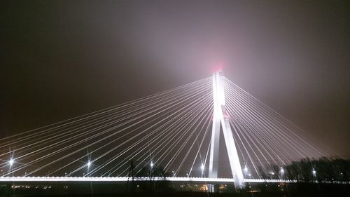 Low angle view of suspension bridge at night