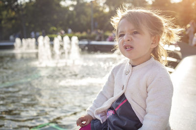 Portrait of cute girl against water