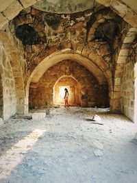 Woman walking in archway