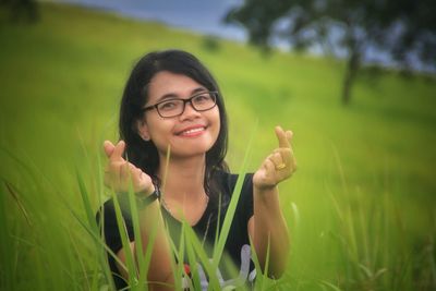 Portrait of smiling young woman in field