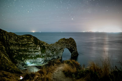 Scenic view of sea against sky at night