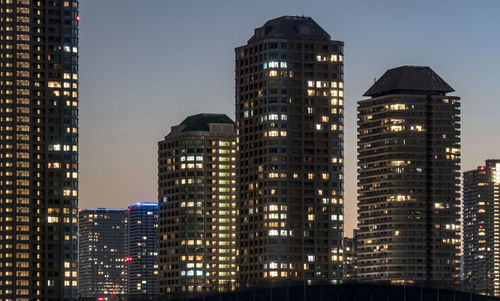 Low angle view of buildings lit up at night