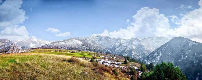 Scenic view of mountains against cloudy sky