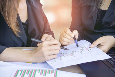 Midsection of woman working on table