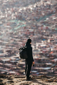 Rear view of woman walking on rock