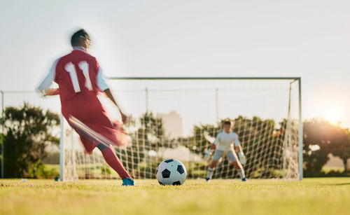 Man playing soccer at park