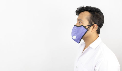 Portrait of young man against white background