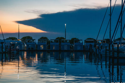 Boats in marina at sunset