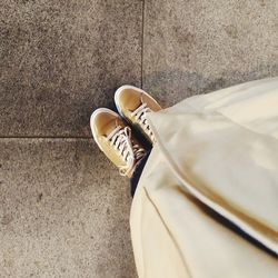 Low section of shoes on tiled floor