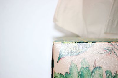 Close-up of tissue box against white background