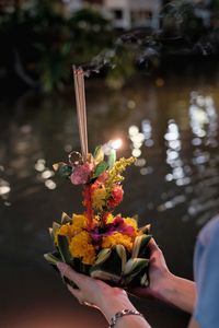 Person holding bouquet of flower on loi kra thong festival in thailand