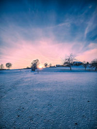 Scenic view of snowed hill against sky