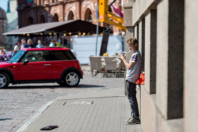 Side view of man on street in city