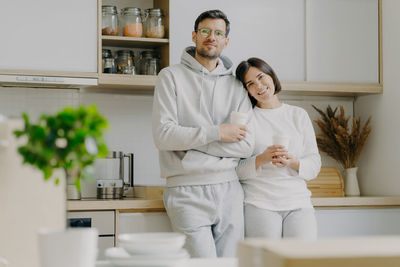 Portrait of smiling couple standing at home