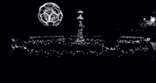 Low angle view of illuminated ferris wheel at night