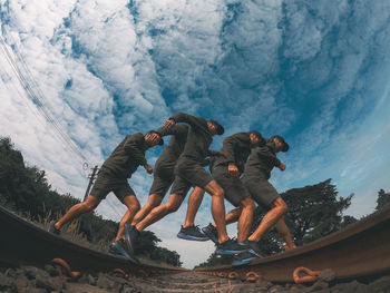 Low angle view of people in water against sky