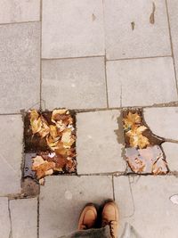 Low section of man standing on sidewalk