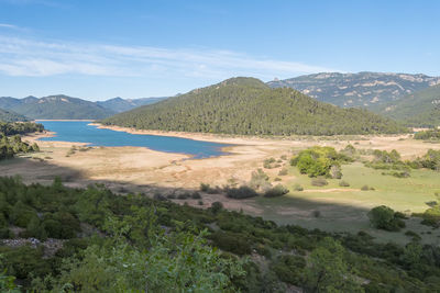 Scenic view of sea and mountains against sky