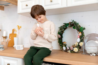 Portrait of cute girl sitting on table